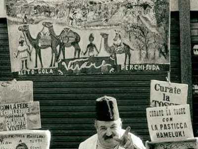 Lui aveva creato un vero e proprio personaggio, ispirato ai venditori ambulanti delle kasbah marocchine. Era infatti impossibile non notarlo, per il modo in cui era vestito, per i manifesti che arricchivano la sua bancarella e per come cercava di vendere le sue pastiglie (foto pubblicata da Bonifacio Rodolfo Pansini nel gruppo facebook "Sei di Molfetta se...")